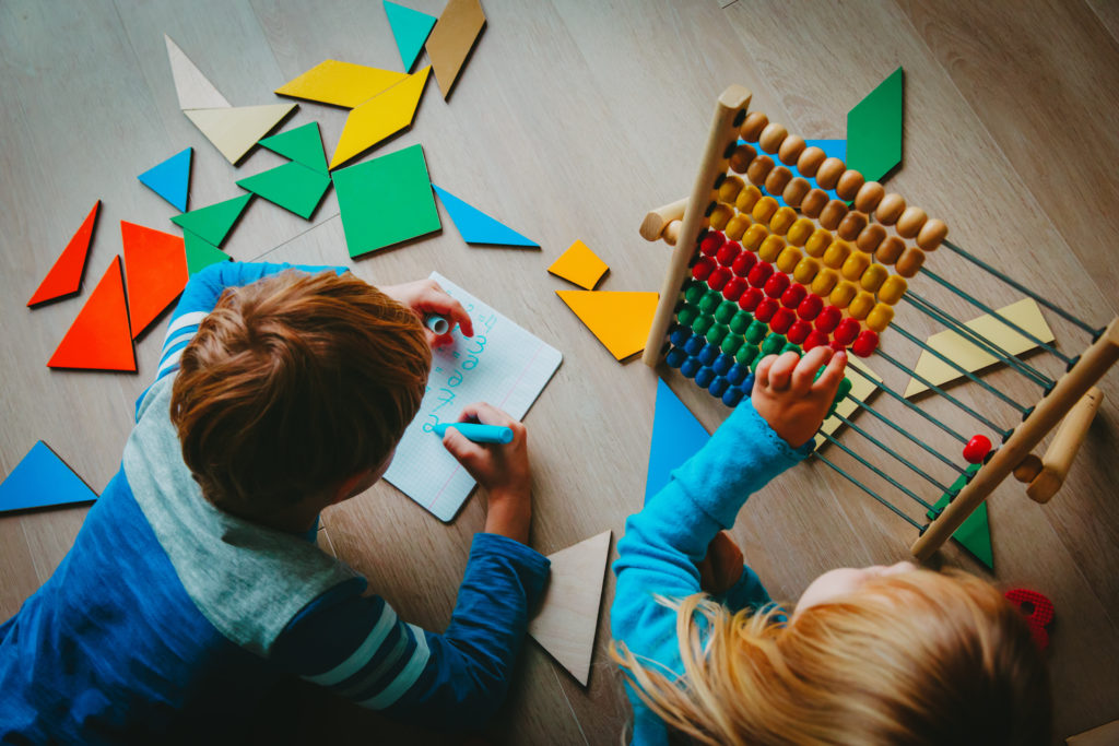 little boy and girl learn to write and calculate numbers