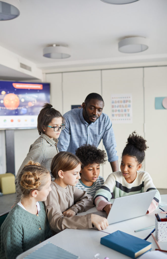 Group of Children Looking at Computer Screen in School