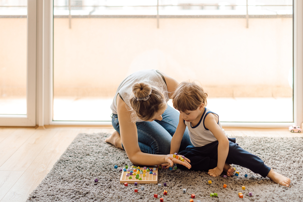 Single mother teaches her 3 year old son how to count. Home teaching account. Development of math skills