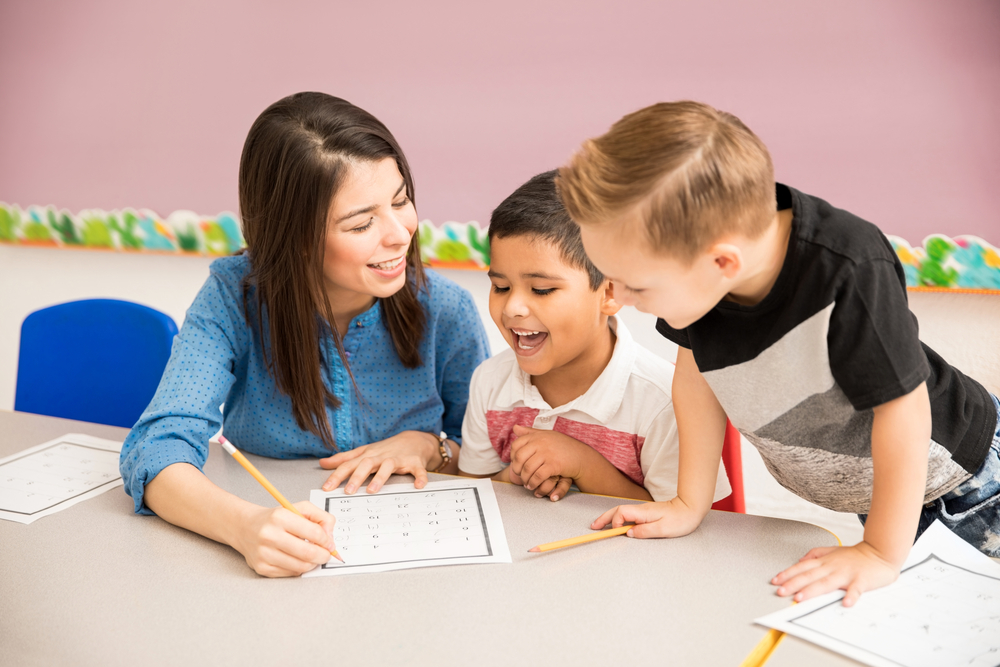 Teacher and pupils having fun at school