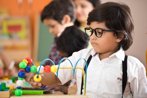 Little boy learning with abacus at preschool