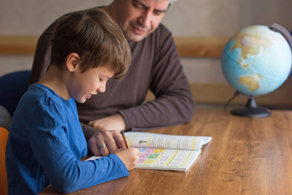 Father and son solving mathematics homework togehter
