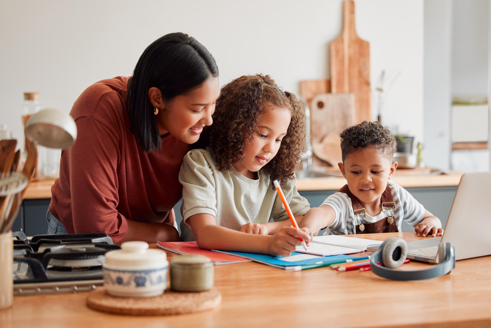 Homeschool, education and distance learning for children while mother, parent and woman helps son and daughter. Teaching, talking and bonding with kids doing home school, homework and learning test