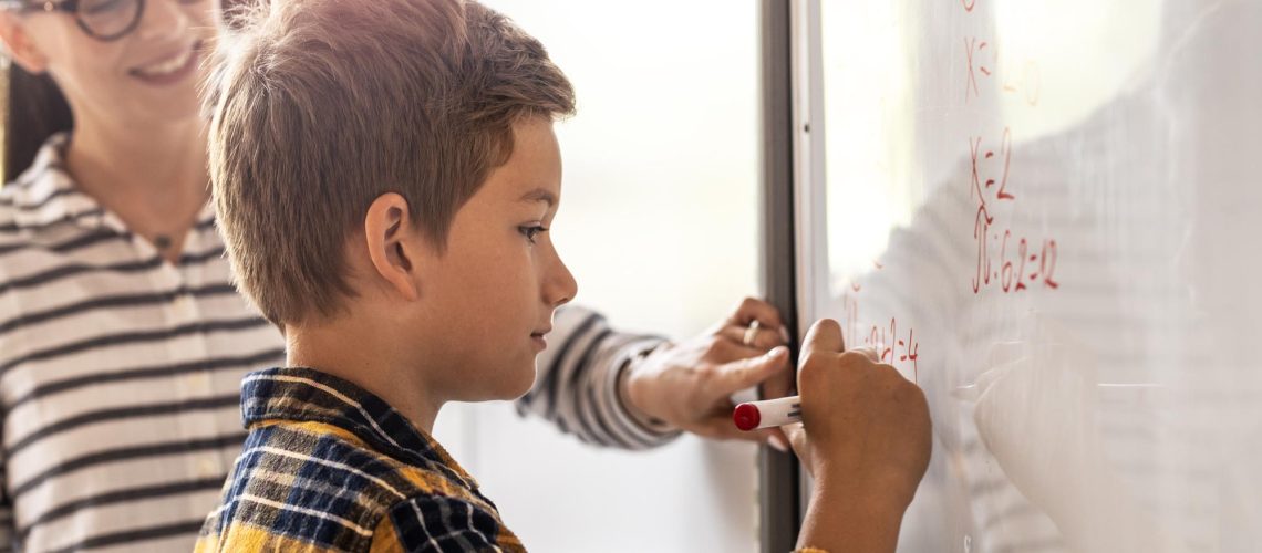 Female teacher helps her student to resolve mathematics problem