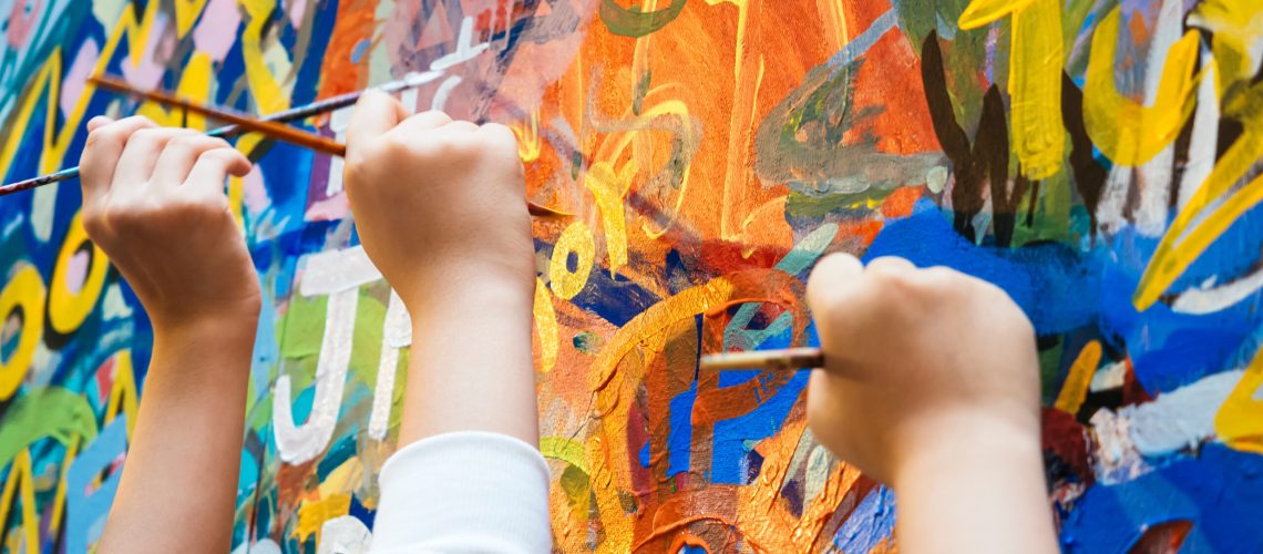 Kids hands with Colourful Paint Background